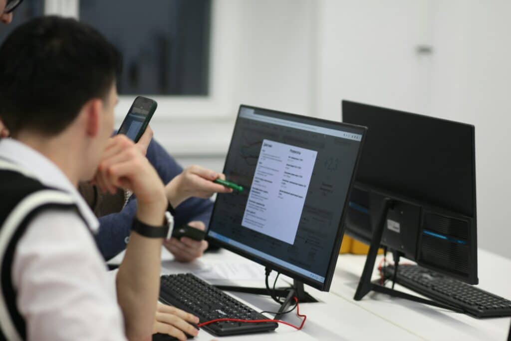 Person Pointing at Monitor - First Party Fraud Detection