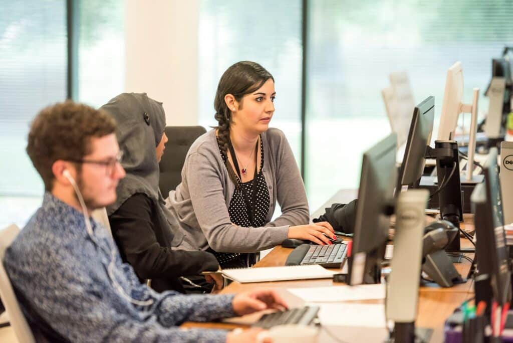 employees working on their computers - Biometrics In Banking