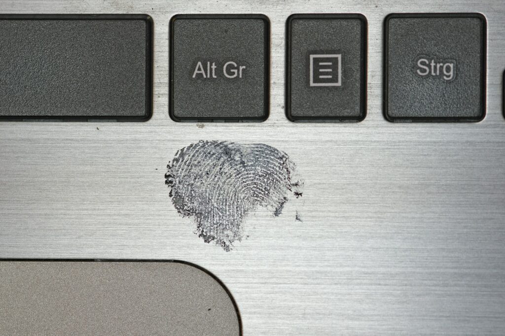 thumb print on a laptop - Biometrics In Banking